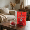 A cozy living room with a bag of Hammond's Cinnamon Pillow Drops next to a candy dish  of the cinnamon pillows, on a coffee table for a snack.