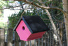 Side view of the pink wren house that is hanging from a tree