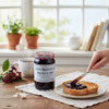 Annie’s Kitchen Elderberry Jelly spread on toast with fresh elderberries and hot tea in a cozy kitchen.