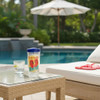 Harvest Array's Life is Short Wear Flip Flops Tumbler with Lid  on a poolside table next to a cup of water with lemon with a view of a swimming pool in the background.