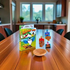 Flippin' Birds game box on a wooden table with game pieces in the background.  Makes a great gift from Harvest Array. Made in the USA