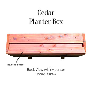 M&M  Enterprises Cedar Planter Box Back view with mounting board shown askew. Easily remove the mounting board and fix it with screws to a porch railing or fence board. Then attach the box.