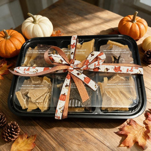 Six Flavor Homemade Toffee Sampler Gift Box  with fall decorations in kitchen. Flavors are:  Butterscotch, Coffee, Dark Chocolate, Milk Chocolate, White Chocolate, and Peanut Butter and can't be changed.