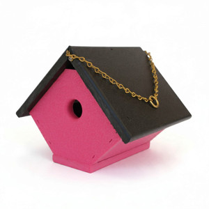 Side view of pink poly wren house with a black roof