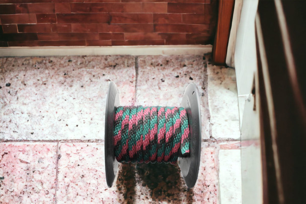 Hunter Green, Burgundy, and Black Solid Braided Multifilament Polypropylene Rope on the barn floor