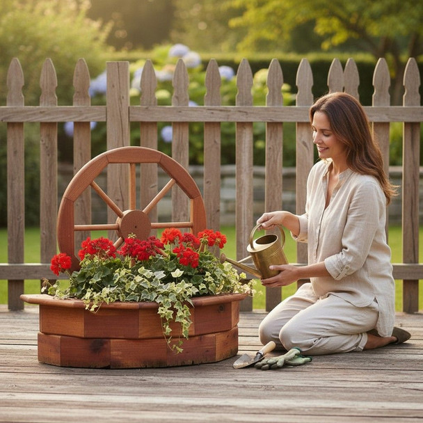 Woman watering red flowers planted in an Amish-made cedar wagon wheel planter on a backyard deck