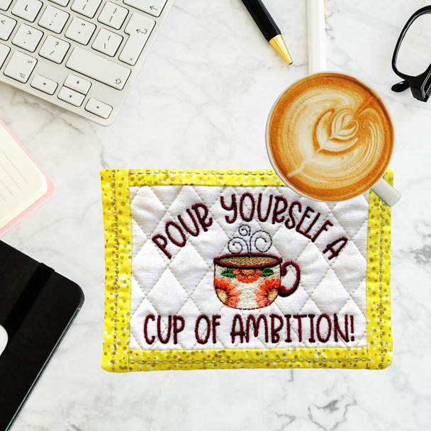 Our Embroidered and Quilted "Cup of Ambition" Mug Rug" is great for keeping your desk clean. Machine Washable.  