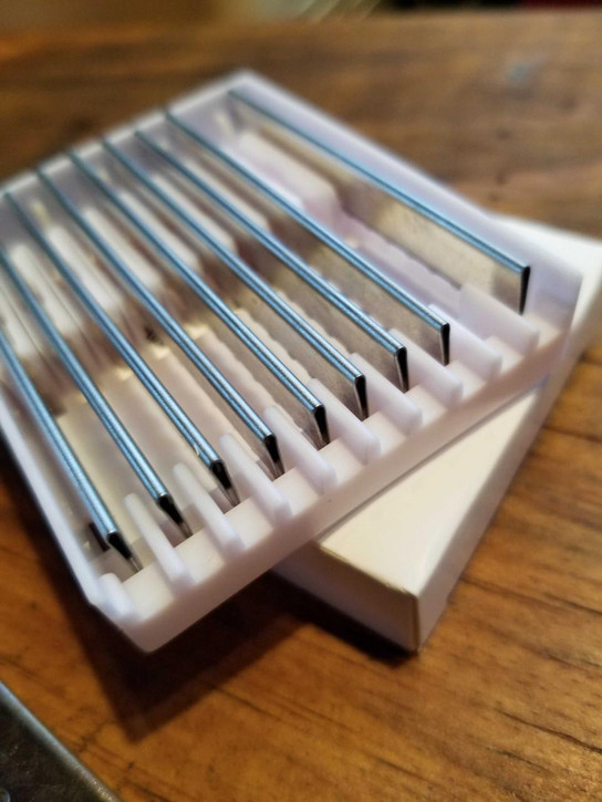 Feather Shear Fanatic®️ Feather Razor Blades 10 Pack, close-up of stainless steel razor blades in a white plastic holder.