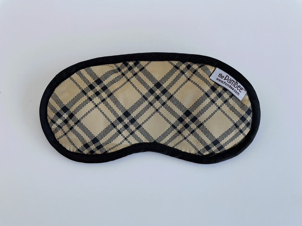 The Notting Hill eye mask is designed with a preppy tan and plaid that has black silky fabrics that will keep your eyes nice and comfy.