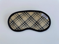 The Notting Hill eye mask is designed with a preppy tan and plaid that has black silky fabrics that will keep your eyes nice and comfy.