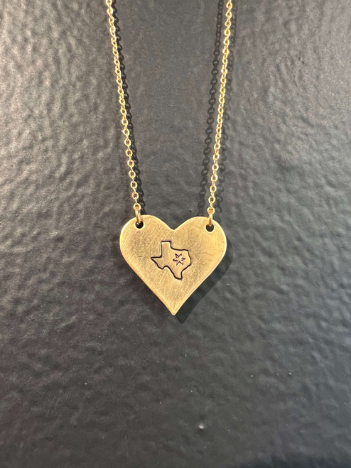 Vintage brass heart hand stamped with a Texas and star hanging on 18” dainty brass chain with gold filled clasp.