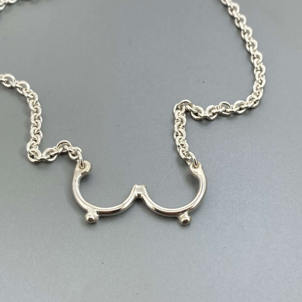 Sterling silver “Bewbs” necklace finished with a sterling silver lobster clasp.