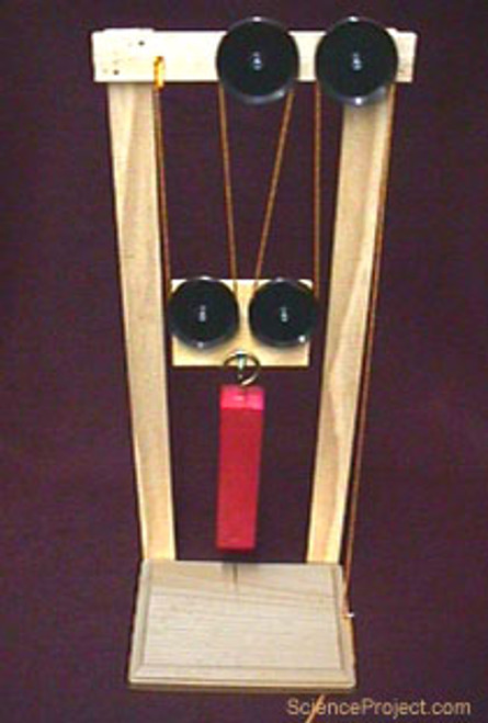 This compound machine was designed and built using five of the sheaves.  It demonstrates the lifting power of these home made pulleys.  Pulleys are often used as parts of compound machines such as this one. They function as helper machines, easing the lifting power. In fact, a pulley system can cut the force necessary to lift a very heavy object in two, four, etc., depending on the designed system. With these pulleys you can study and measure the force and distance trade off with compound machines. These pulleys are good for science experiments as well as functional tasks.