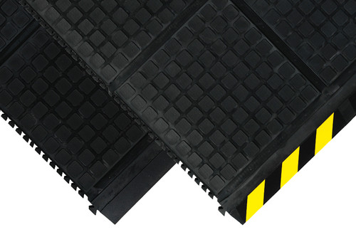 Corner of black Hog Heaven Linkable mats. One has a beveled edge with yellow striped border, and the other edge is black with interlocking mechanisms. Another black tile is underneath with the corner showing: both sides of tile have the interlocking mechanisms. Corner of black Hog Heaven Linkable mats. One has a beveled edge with yellow striped border, and the other edge is black with interlocking mechanisms. Another black tile is underneath with the corner showing: both sides of tile have the interlocking mechanisms.