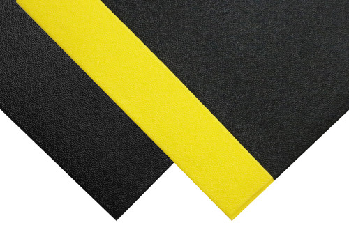 Corner of charcoal colored Sure Cushion Mat with yellow border sitting on top of corner of solid charcoal colored Sure Cushion Mat. Corner of charcoal colored Sure Cushion Mat with yellow border sitting on top of corner of solid charcoal colored Sure Cushion Mat.