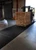 Forklift carrying a stack of pallets across a long WaterHog Forklift Mat inside a warehouse.