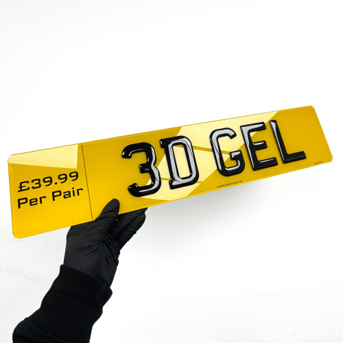 3D gel number plate held at an angle, showing raised domed lettering on a yellow rear plate