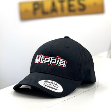 The Utopia Plates branded logo black cap with the company logo in the background