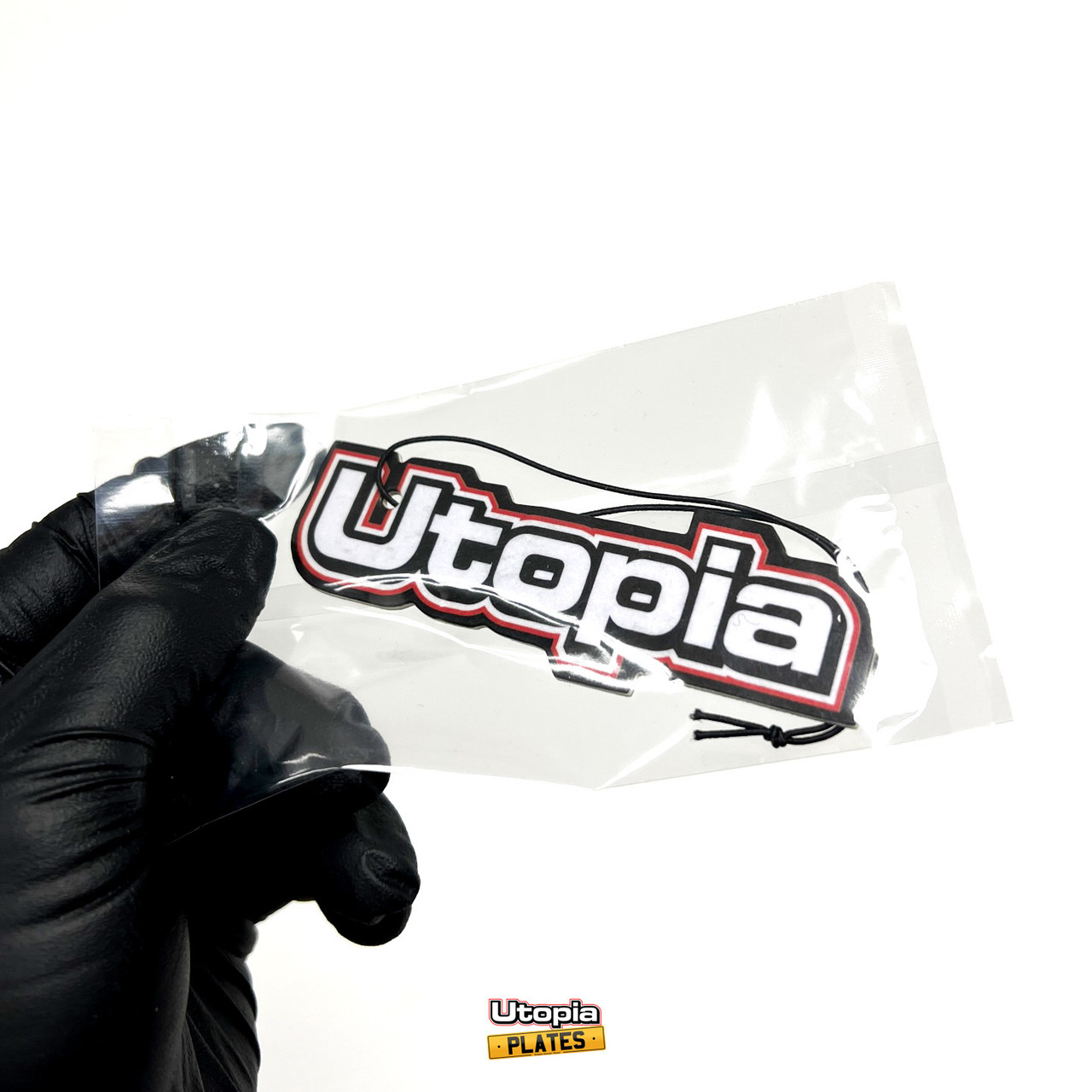 The Utopia Plates air freshener, sealed in a bag for freshness