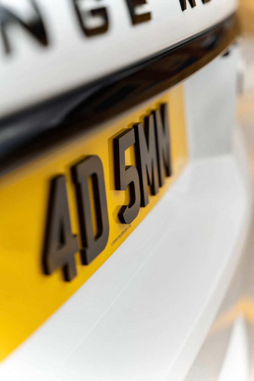 Close angled shot of a 4D 5mm rear number plate showing the depth of the raised characters