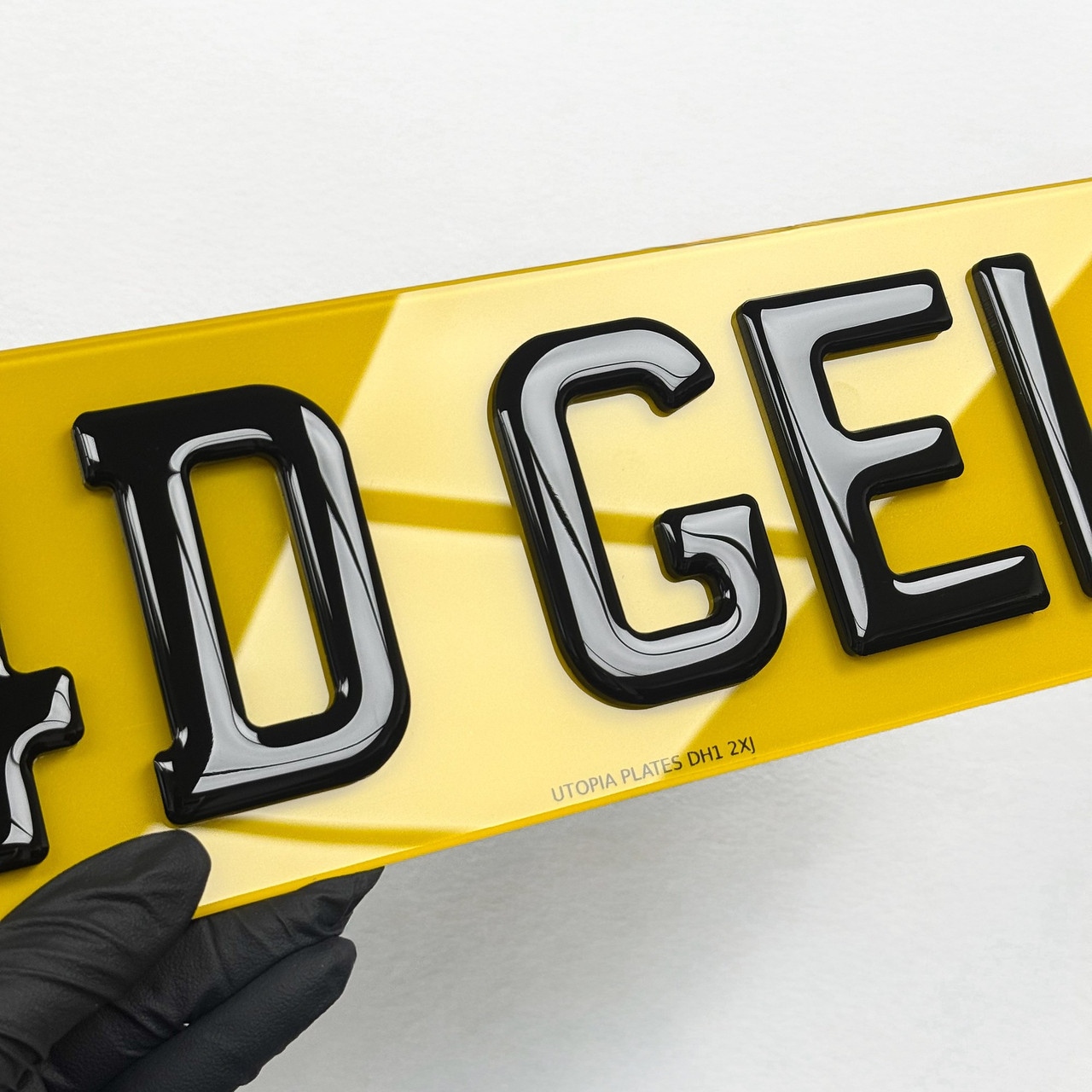 Close-up of 4D gel number plate lettering, showing the gel dome over each raised character