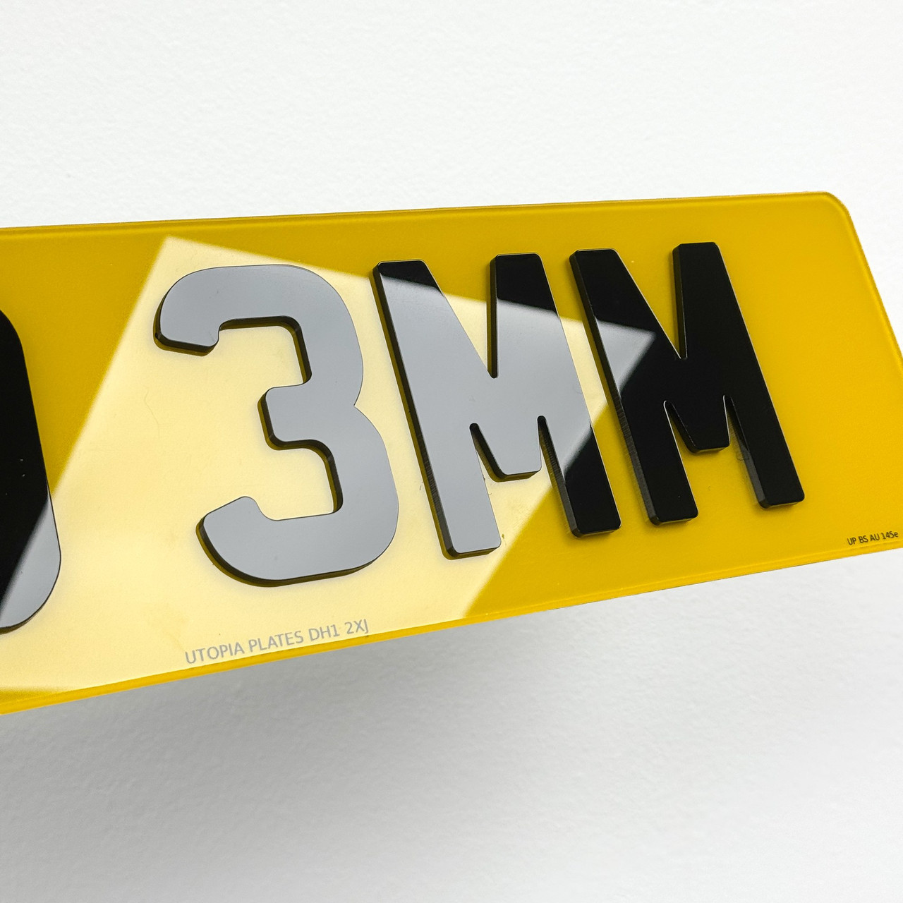 Close-up of 3mm 4D number plate letters, showing the flat-topped acrylic edge in profile