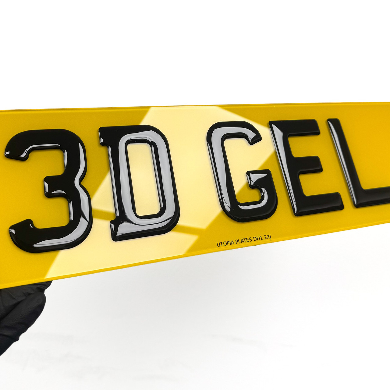 Close-up of 3D gel number plate lettering, showing the resin dome over each character