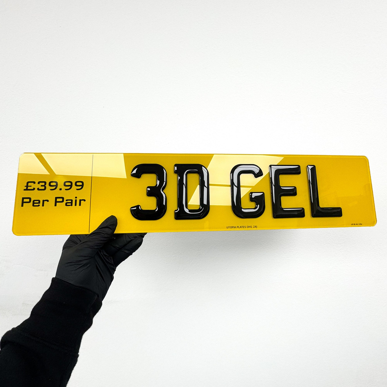 Yellow rear 3D gel number plate shown face on, with glossy domed black characters