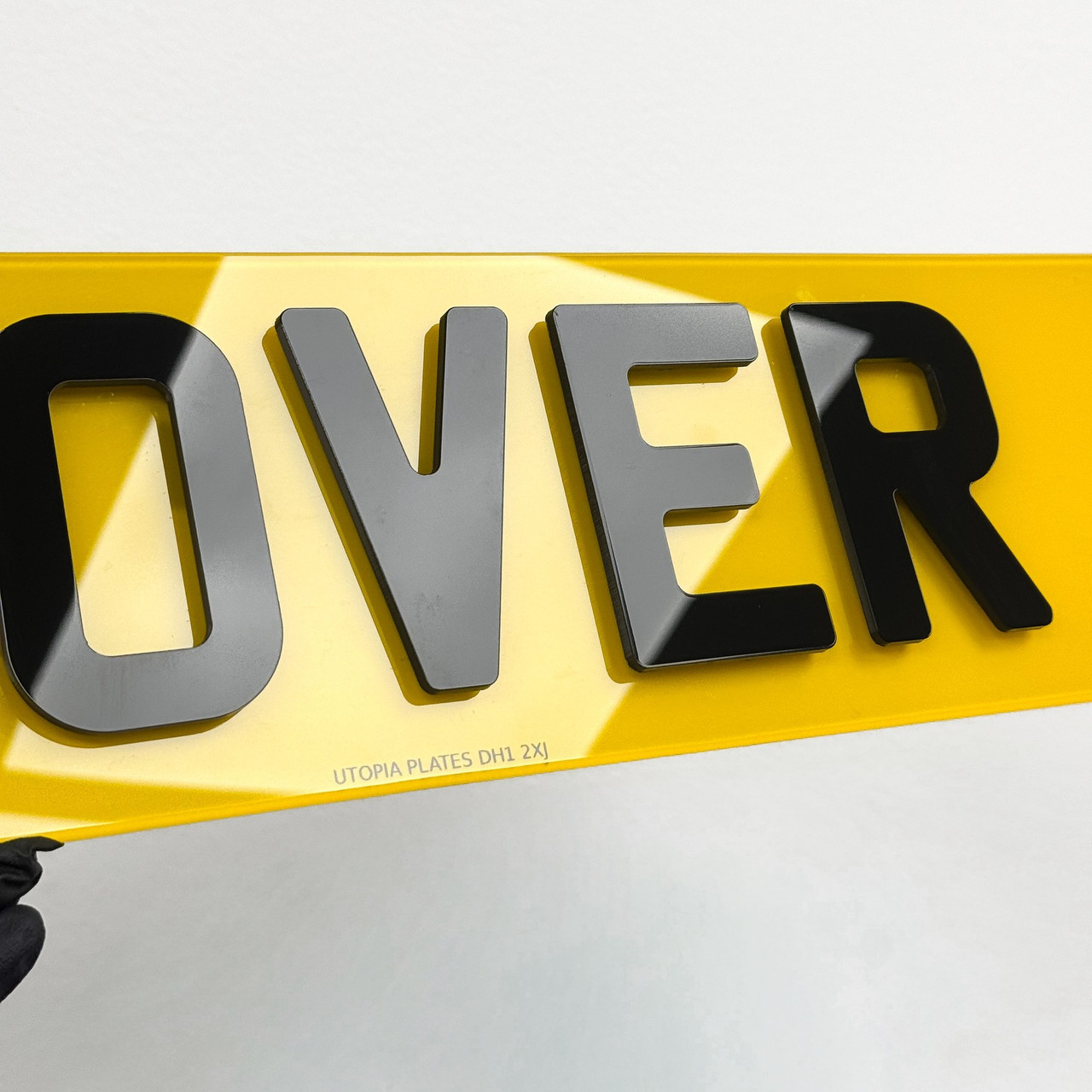 Close-up of hover style number plate lettering, showing the dark edges