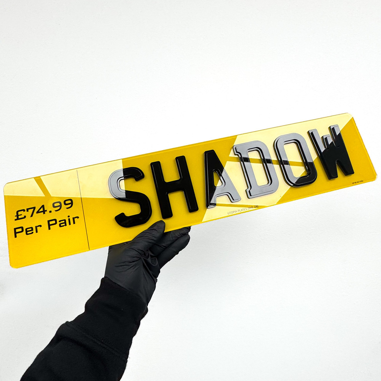 Shadow style number plate with black characters backed by an offset layer