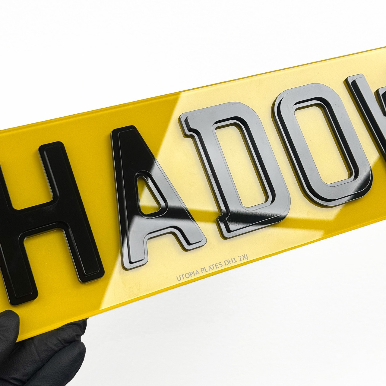 Close-up of shadow style number plate lettering, showing the layer set behind each black letter