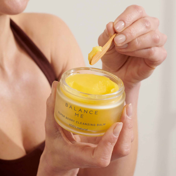 Super Berry Cleansing Balm being scooped out by model