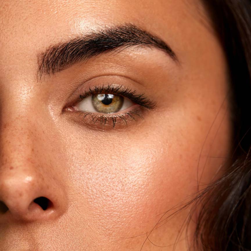 Closeup of hazel eyes woman with Seint makeup.
