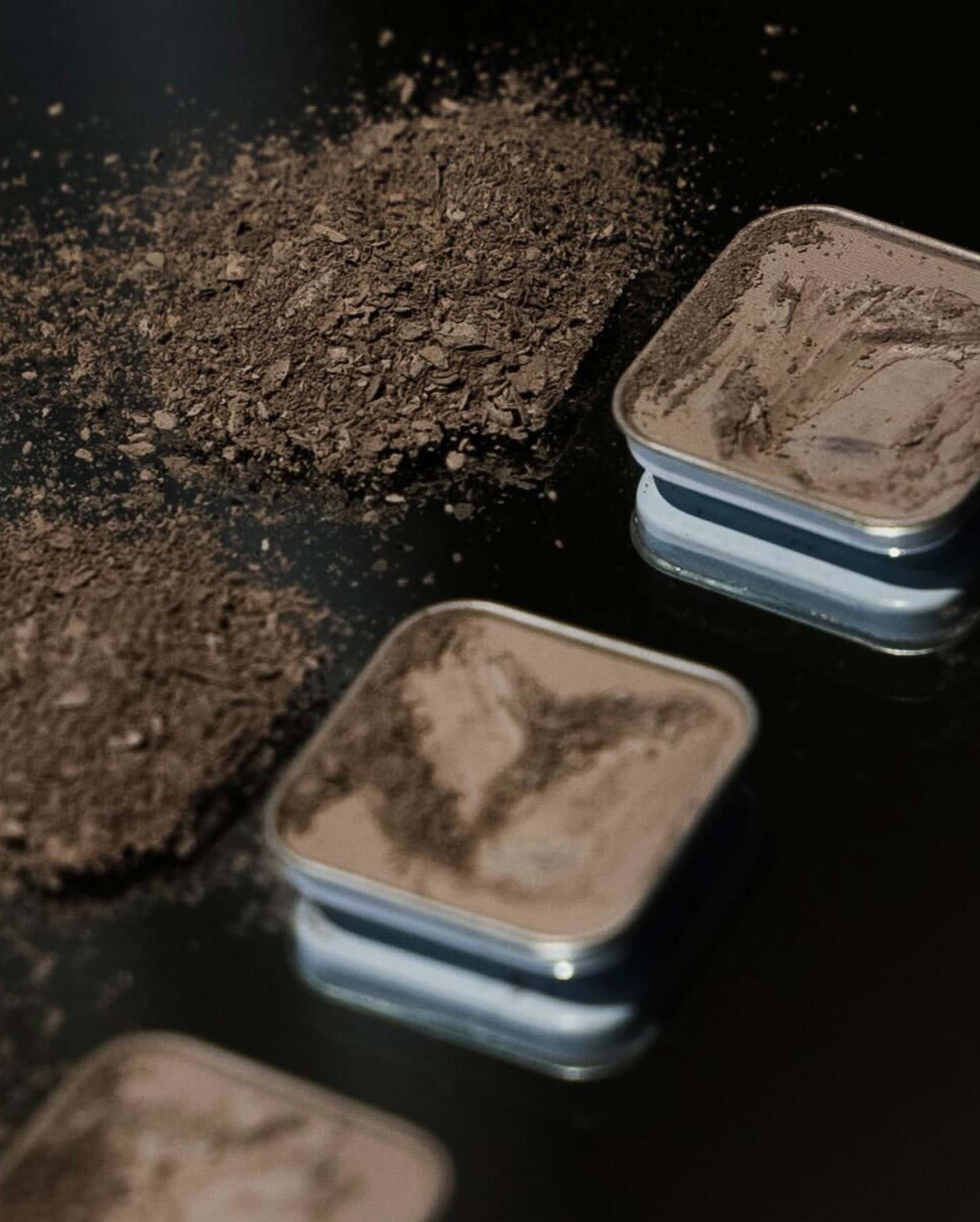 3 eyeshadow palletes next to small collection of shavings.