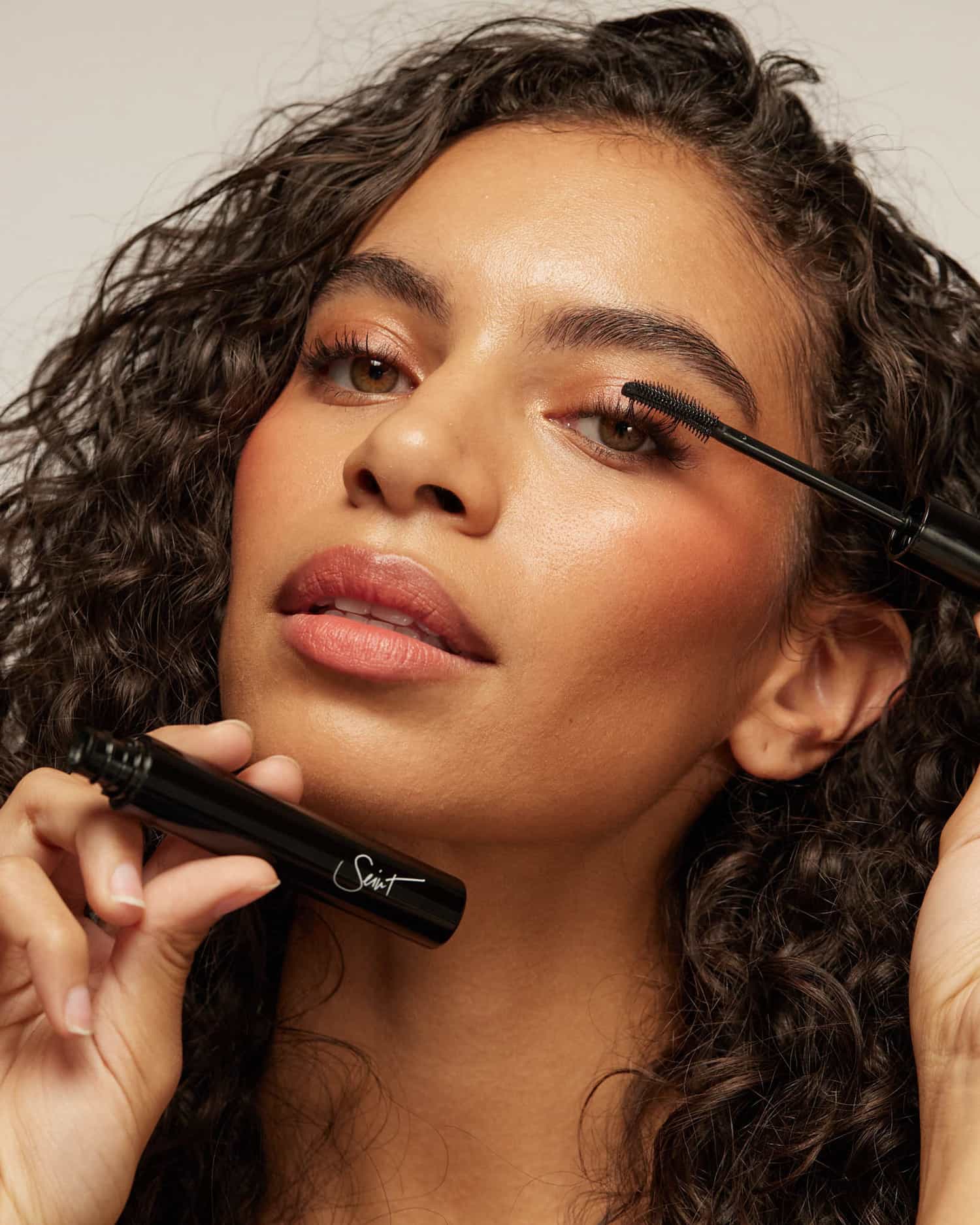 Woman applying Lash Silk product on left eye