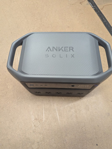 Top view of a grey Anker SOLIX power station highlighting a textured surface and dual built-in carrying handles.