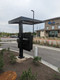 Rear angle view of a double 55-inch LG XE4 outdoor digital kiosk installed in a commercial drive-thru location.