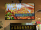 A 50" LG Lite Duty Smart Screen mounted above a service counter, displaying a promotional "Grilled Tofu" menu item.