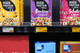 Retail shelf stocked with cereal boxes featuring digital electronic shelf labels showing pricing.