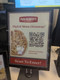 A digital menu sign featuring a Papa Murphy’s QR code for a franchise owner giveaway.