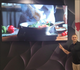 A demonstration of a high-definition 98-inch commercial display in a professional setting, featuring culinary visual content to illustrate effective retail engagement and marketing capabilities.