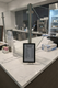 Digital menu board for "Smart Food Purpose" on a clean, white marble countertop in a modern café setting.