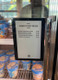 Digital smart label sign in a retail freezer listing "Good Stuff to Go" ice cream treats and prices.
