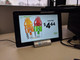 10-inch CM30 Chrome OS touch screen mounted on a desk displaying a retail beverage promotion.