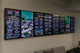 A wall-mounted array of 75" LG Lite Duty Smart Screens displaying a comprehensive cafe menu board.