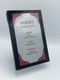 An angled view of a sleek black digital sign displaying a daily bakery menu selections list.
