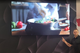 An 86" LG Lite Duty Smart Screen displaying a culinary demonstration video of vegetables being sautéed in a pan.