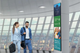 Vertical installation of an 86 inch Ultra Stretch LG commercial smart screen displaying digital signage information.