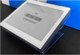 A 4.2 inch digital display label securely positioned on a 25 degree clear L-style easel stand.
