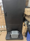 Back panel of a black digital signage kiosk with an Anker SOLIX power station resting in the bottom tray.